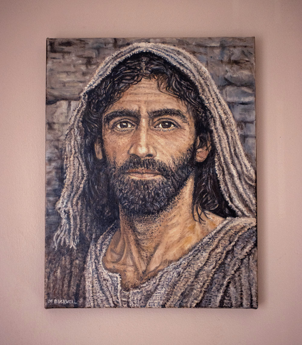 A real photograph of an original oil painting of a Historically accurate Jesus portrait hanging on a wall by Martin Buckwell